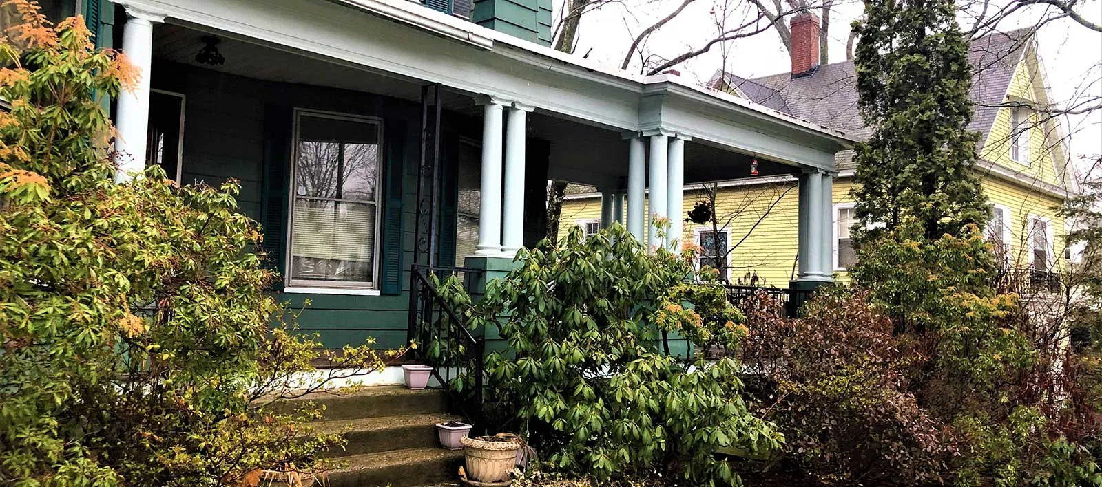 home with a view of a porch and some bushes
