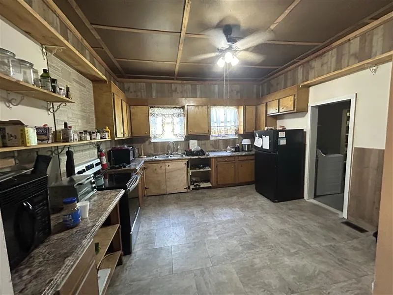 Large kitchen with wood cabinets and open shelving