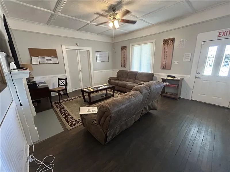 Living room with sectional sofas and front entry door