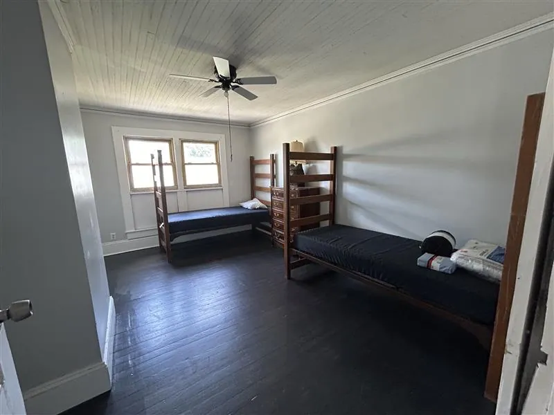 Shared bedroom with two wooden bed frames